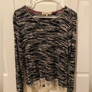 Black and white long sleeve sweater with hem detailing